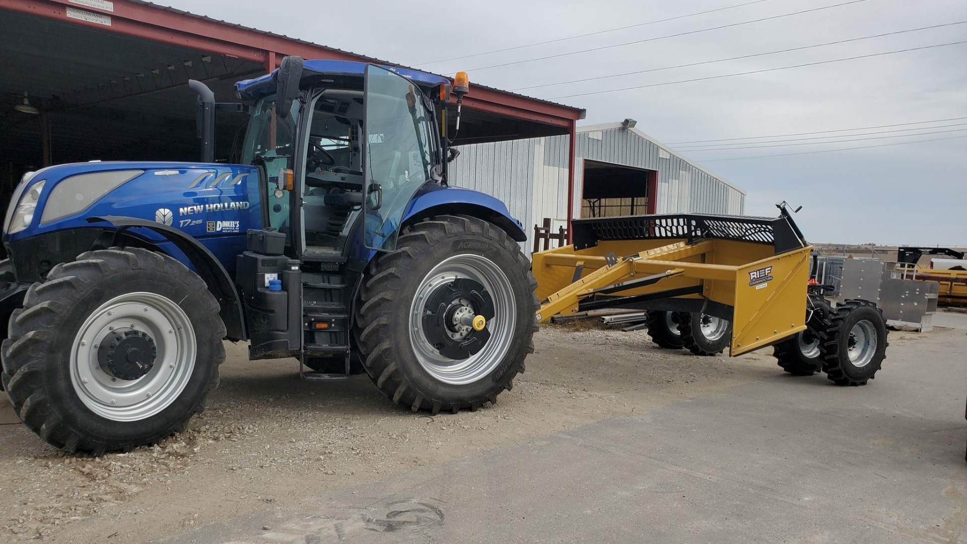 A Rief V-Blade scraper mounted on a New Holland Tractor